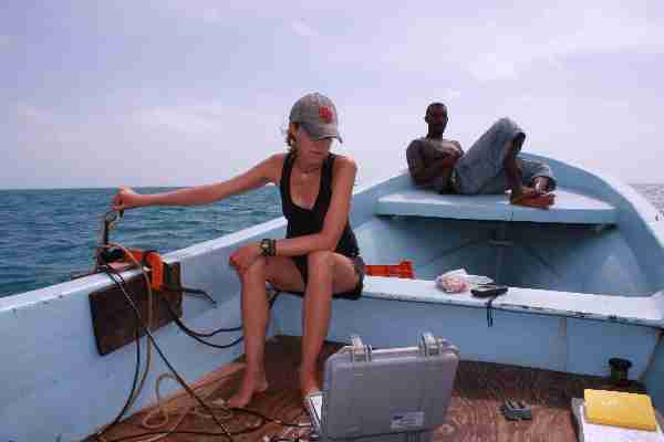 Figs 10-11. Searching for turtles with the Vemco V100 tracking unit (grey box) and the VH110 hydrophone (in the water).