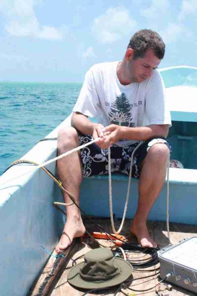 Figs 10-11. Searching for turtles with the Vemco V100 tracking unit (grey box) and the VH110 hydrophone (in the water).